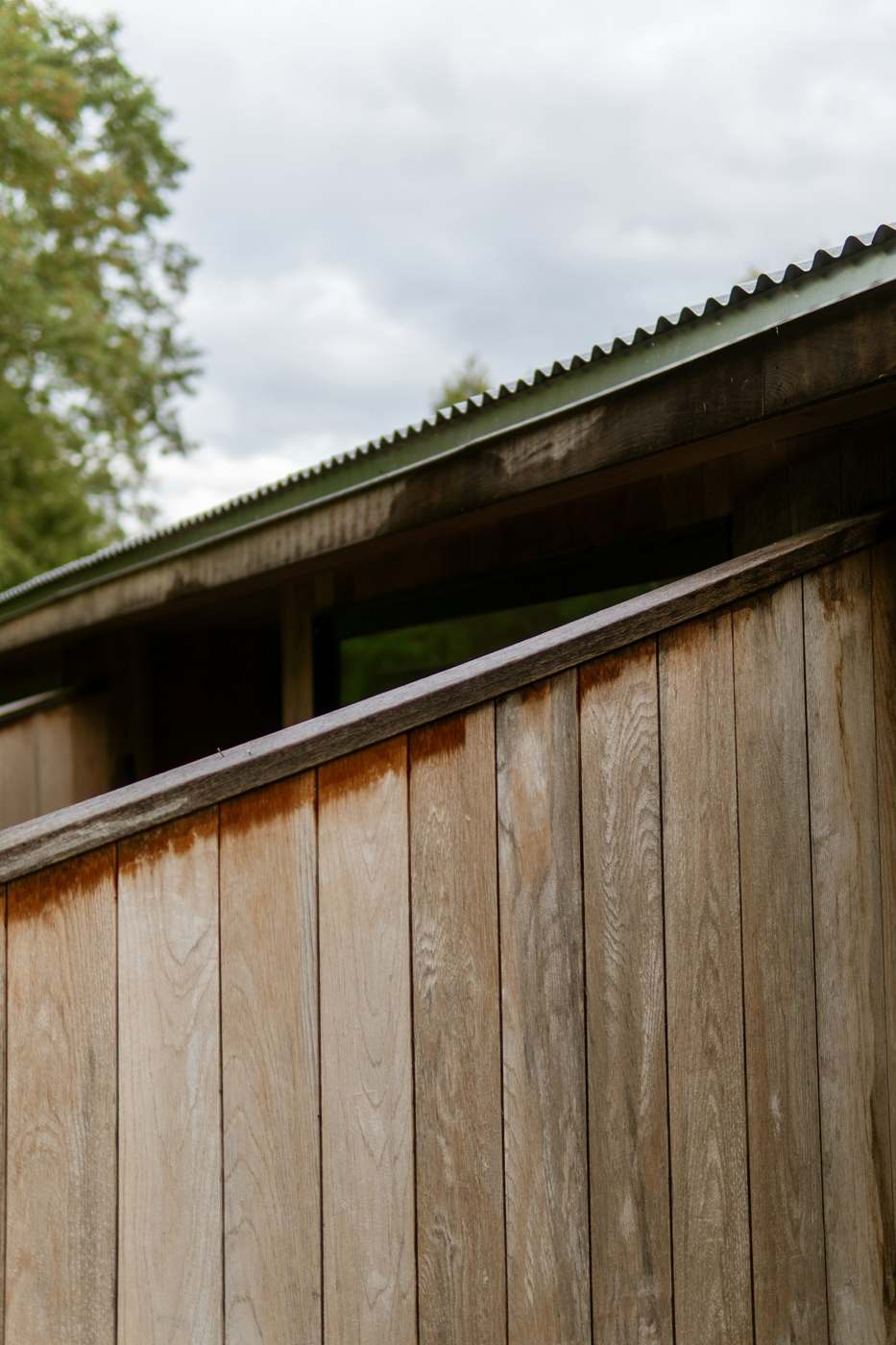 Corrugated metal roof edge against timber