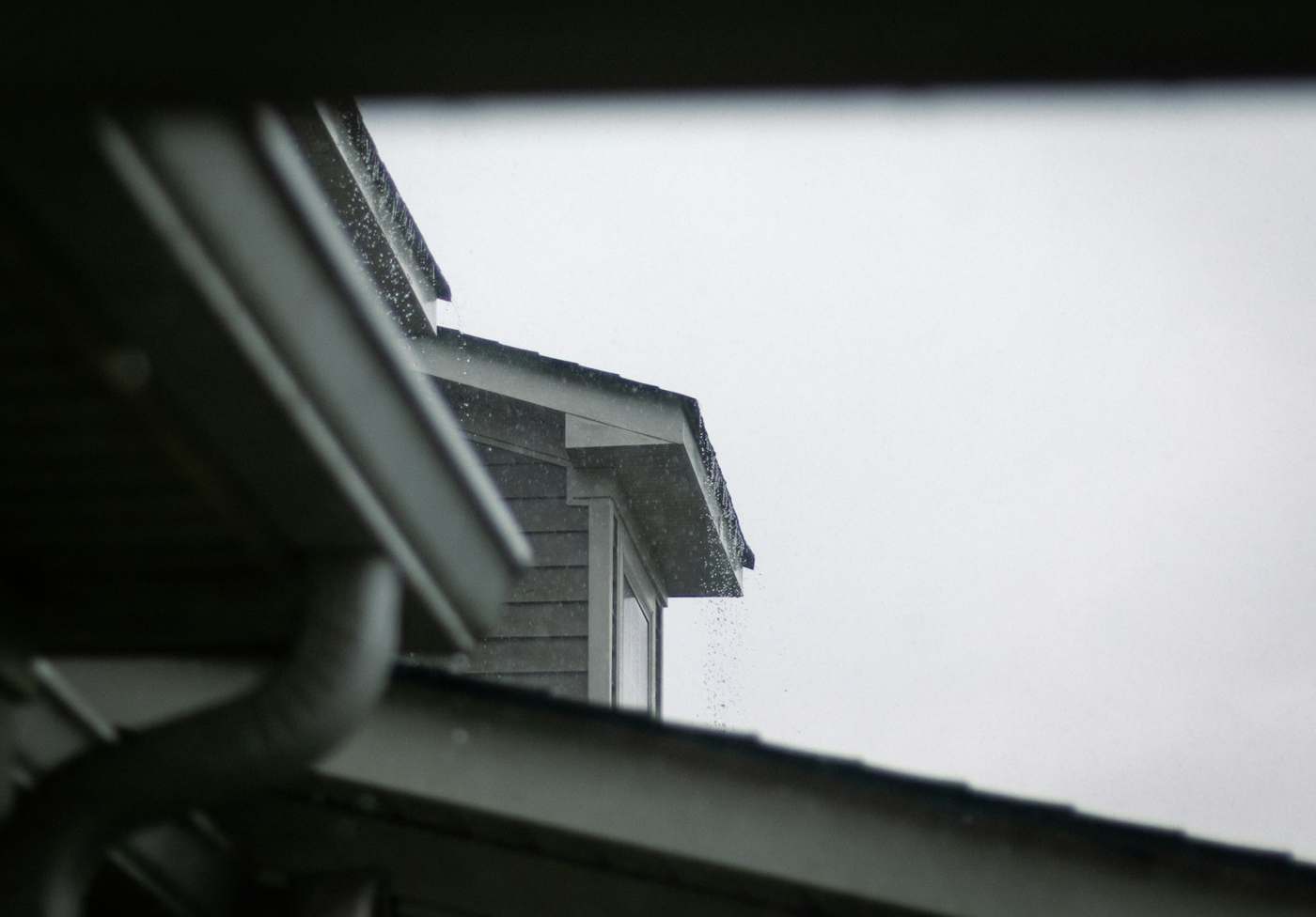 House gutter and downpipe in the rain